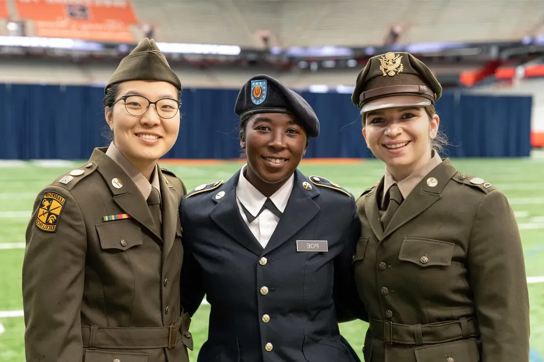 Army ROTC and Air Force ROTC students standing and smiling togehter.